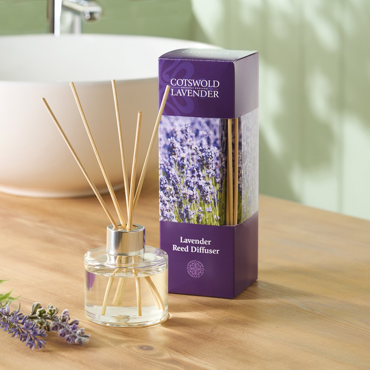 Wooden diffuser and lavender oil bottle in cozy room